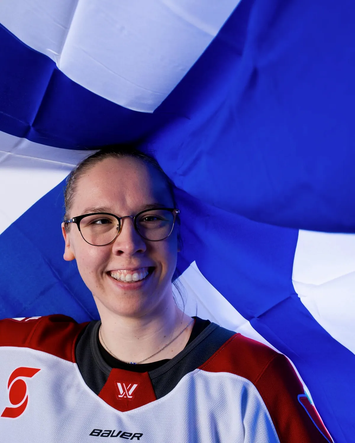 Sanni Ahola, studio portrait with the Finnish flag